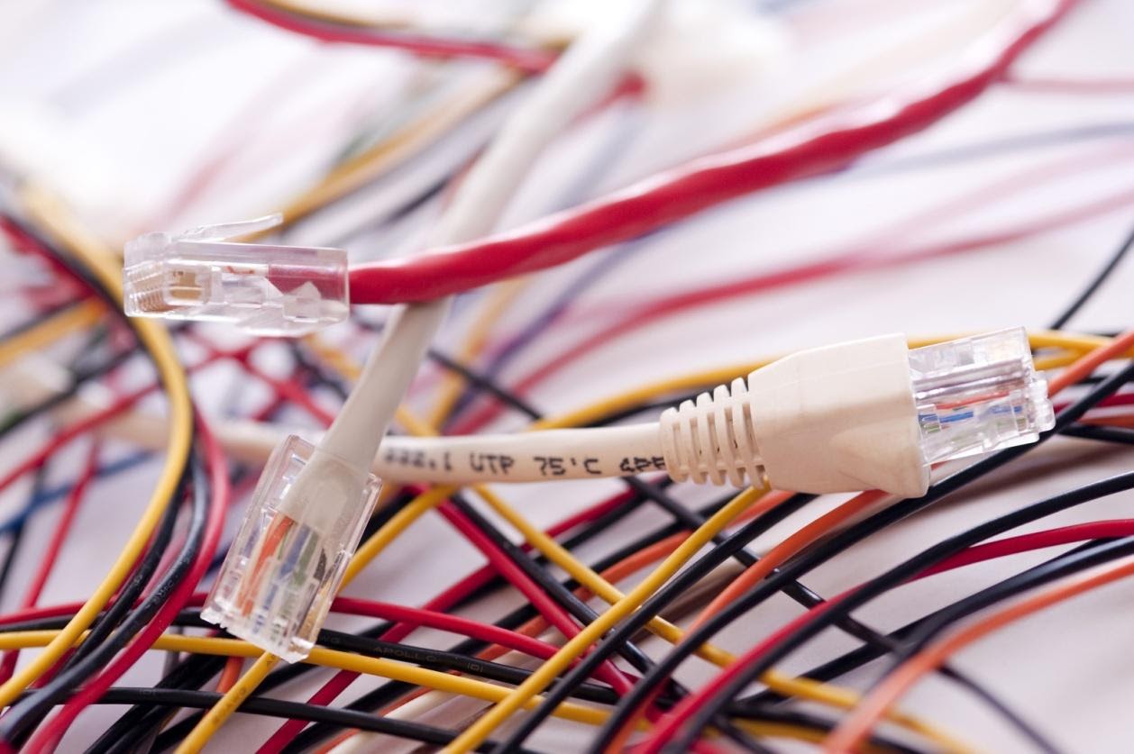 A tangle of colorful cables on a white surface.