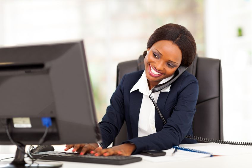  Black woman on phone and computer smiling