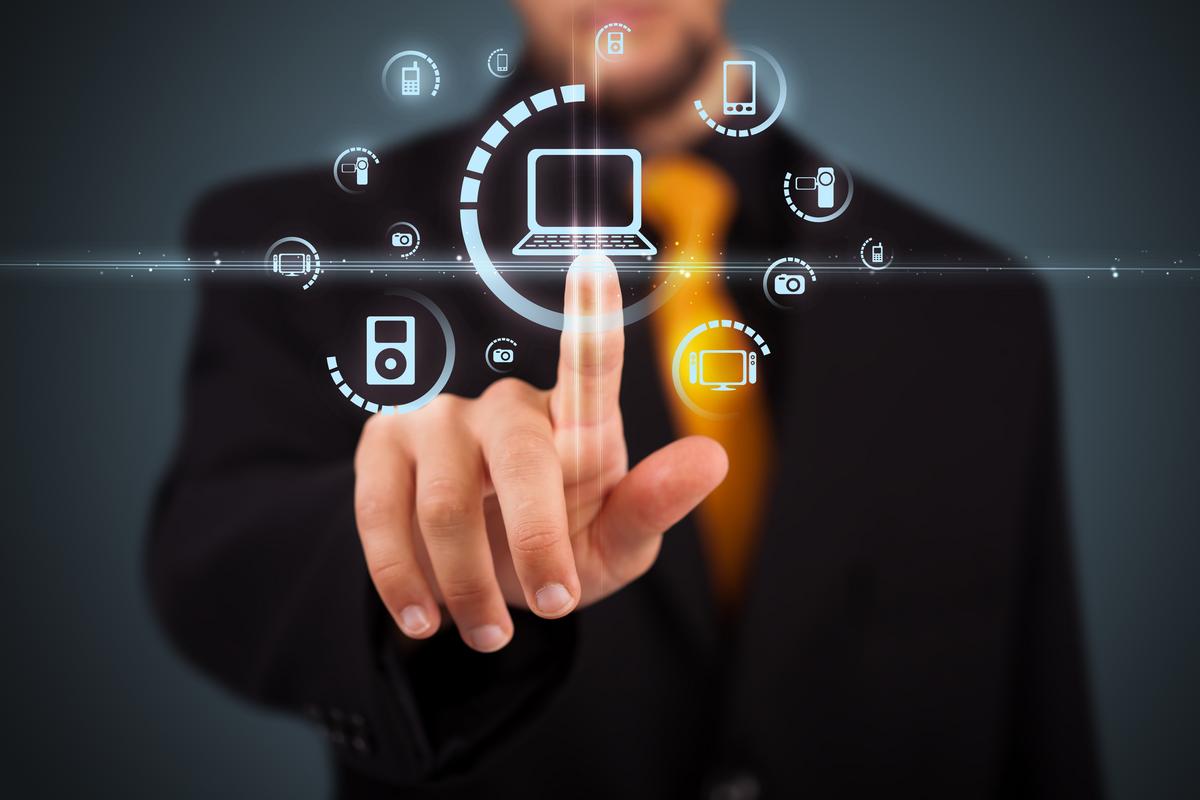Man pointing at digital device icons