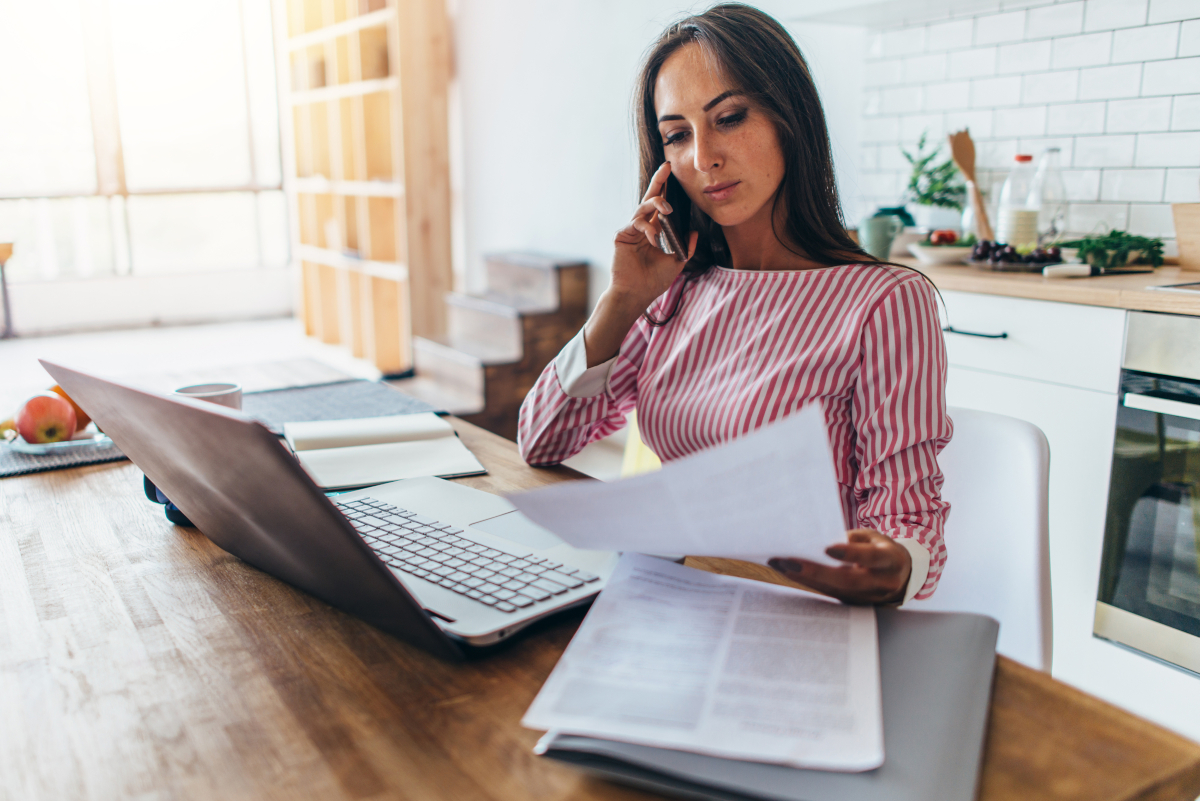 A woman working remotely and using her cellphone