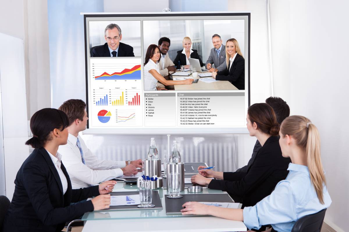 Four Business people video conferencing with colleagues