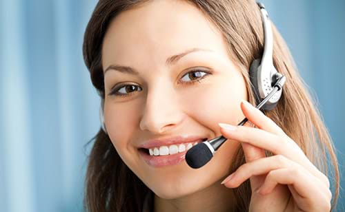 Smiling Customer Service Representative Wearing Headset and Adjusting Microphone