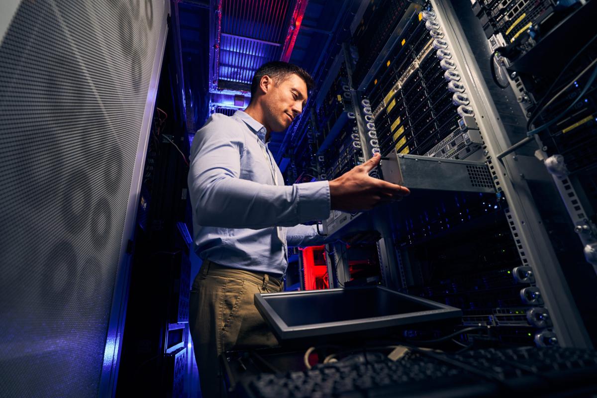 Person working in server room.